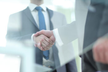 Business handshake. Close up of business men shaking hands