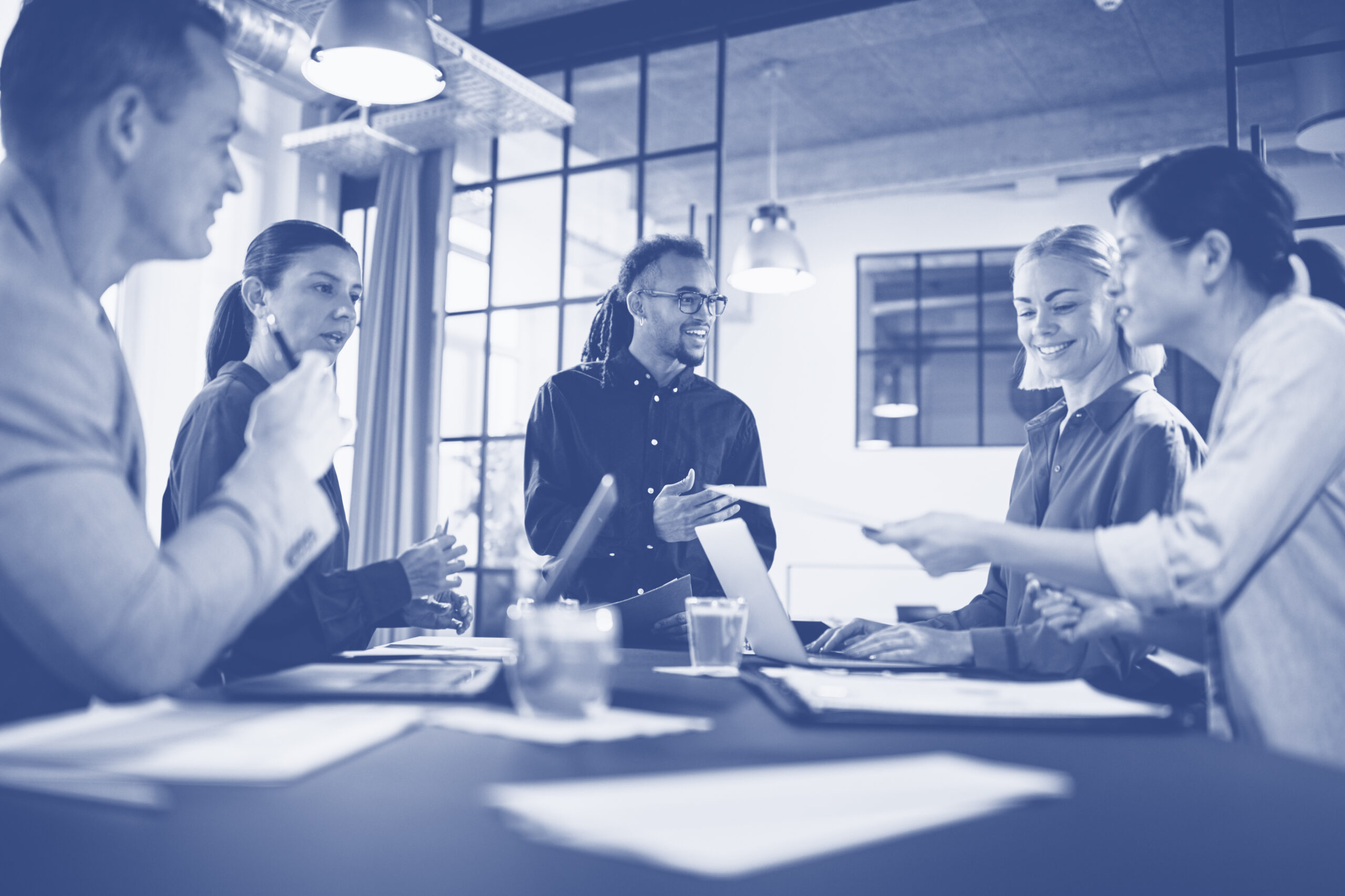 Young businessman talking with staff during an office meeting