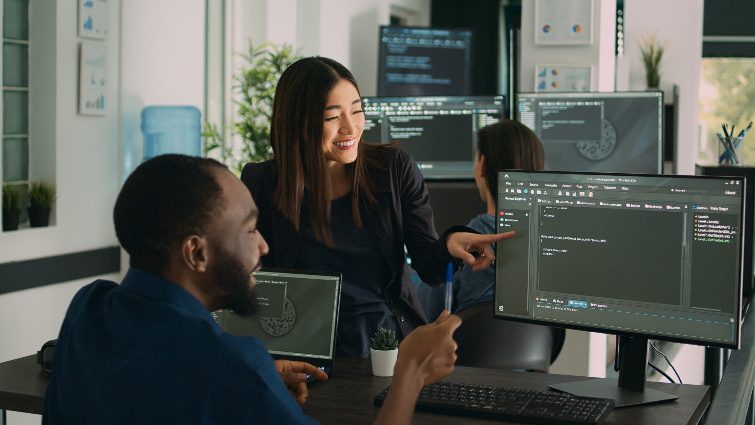 Team of diverse programers doing highfive gesture after coding database