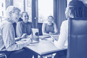 Laughing, planning business and women in a meeting for strategy, teamwork and a workforce team. Happy, office and diversity with people at work for a corporate collaboration and coworking together