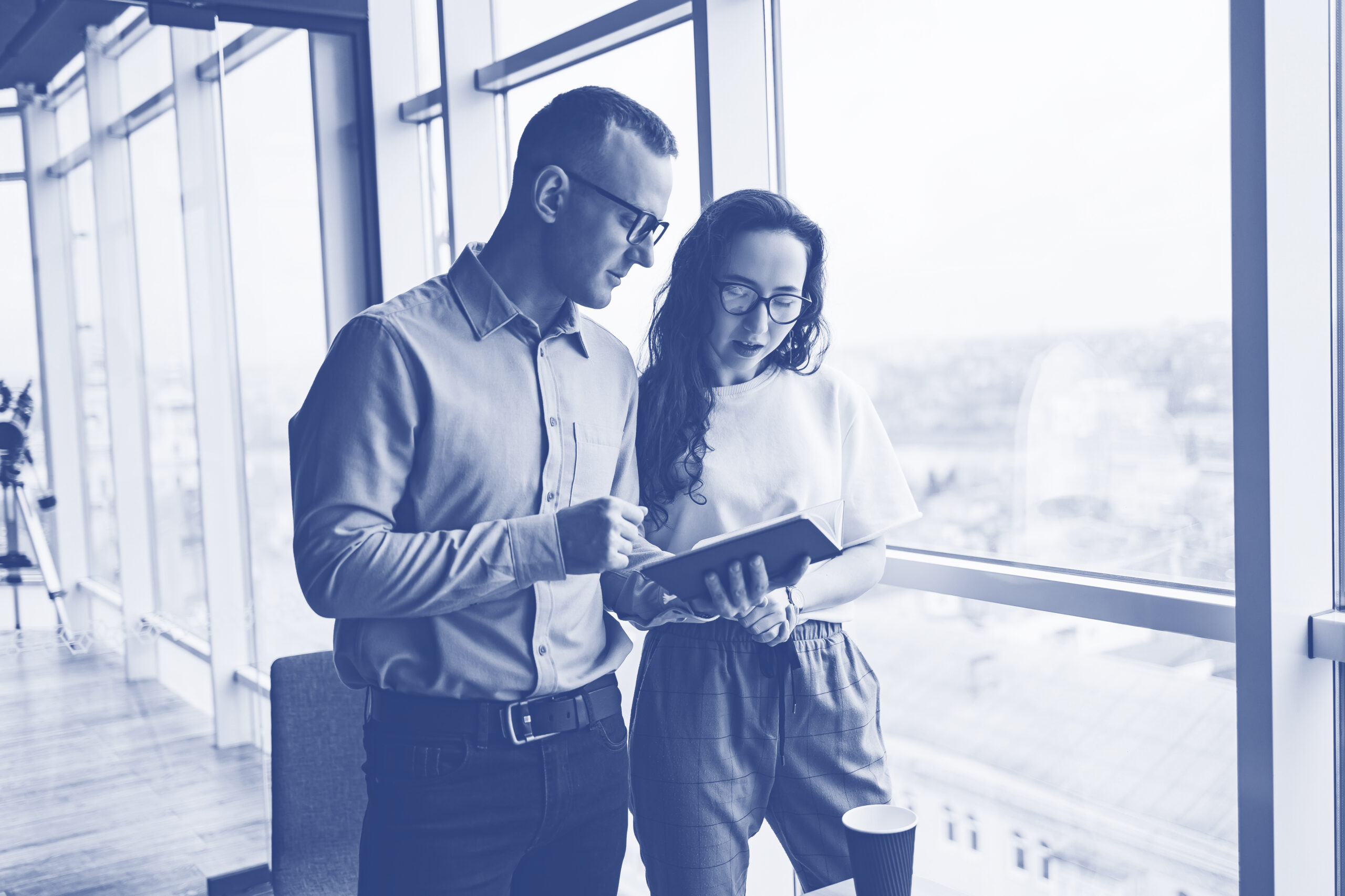 Young male and female colleagues work in a spacious office. Successful people are working on a new business project. Collective work in the office