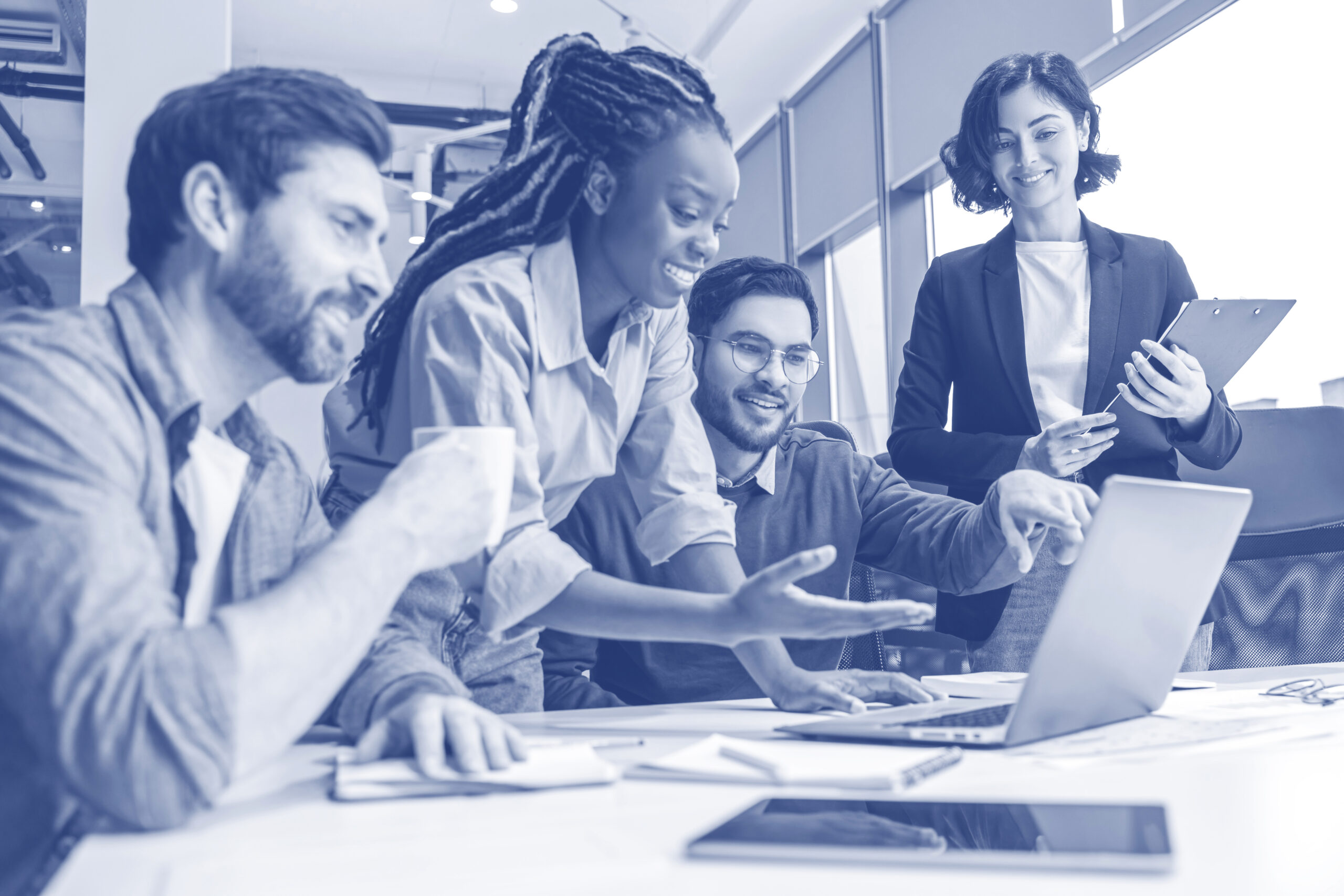 Group of diverse businesspeople using laptop while working together