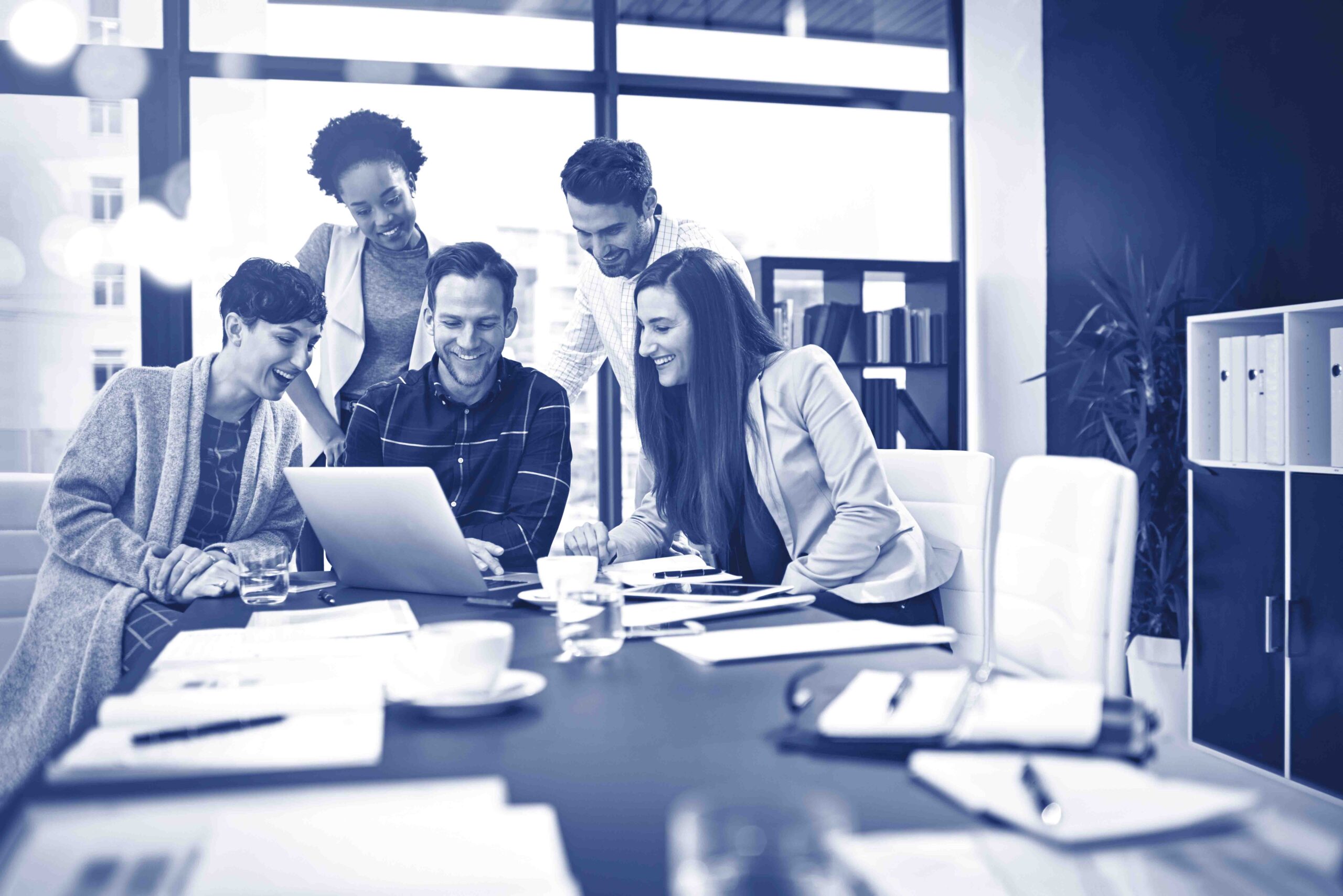 Working towards developing their skills together. Cropped shot of a group of businesspeople working together on a laptop in a modern office.