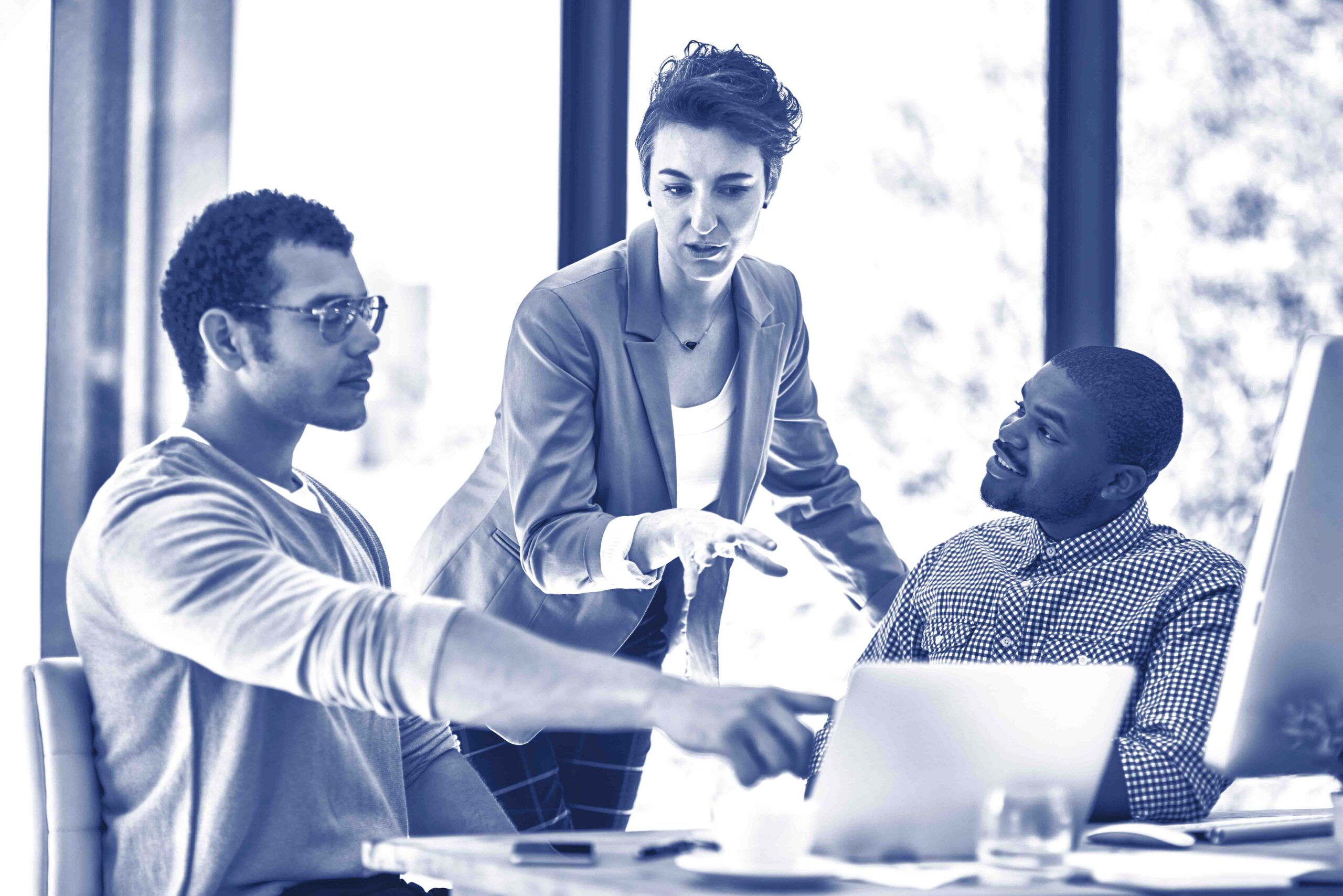 Technology helps teams collaborate to complete projects quickly. Cropped shot of three designers having a brainstorming session at the office.